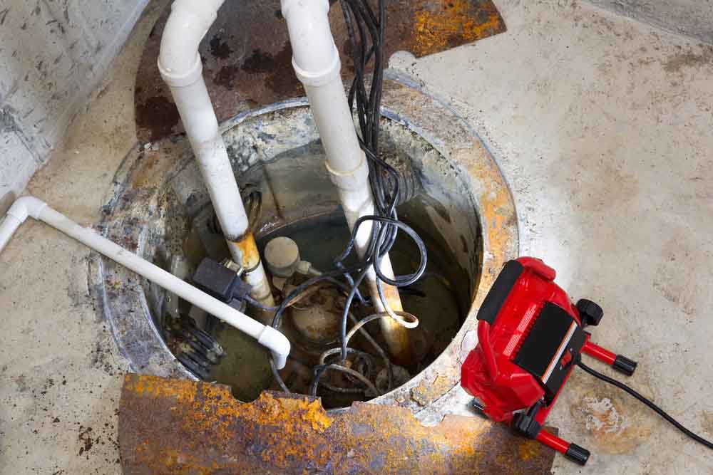 sump pump repair in a basement with a red LED light
